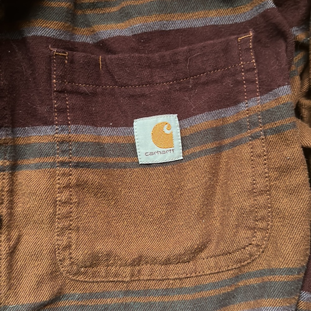 Carharrt patterned flannel. Size Medium. Had purple and tan colored stripes.